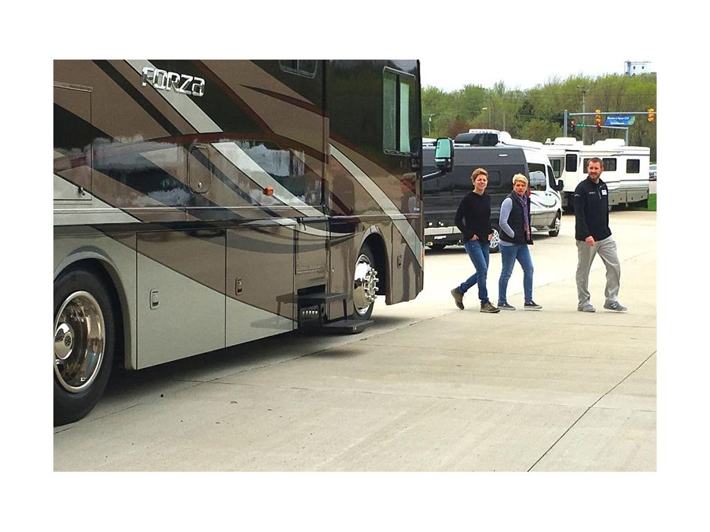 Ann and Lin walking with dealer next to Forza