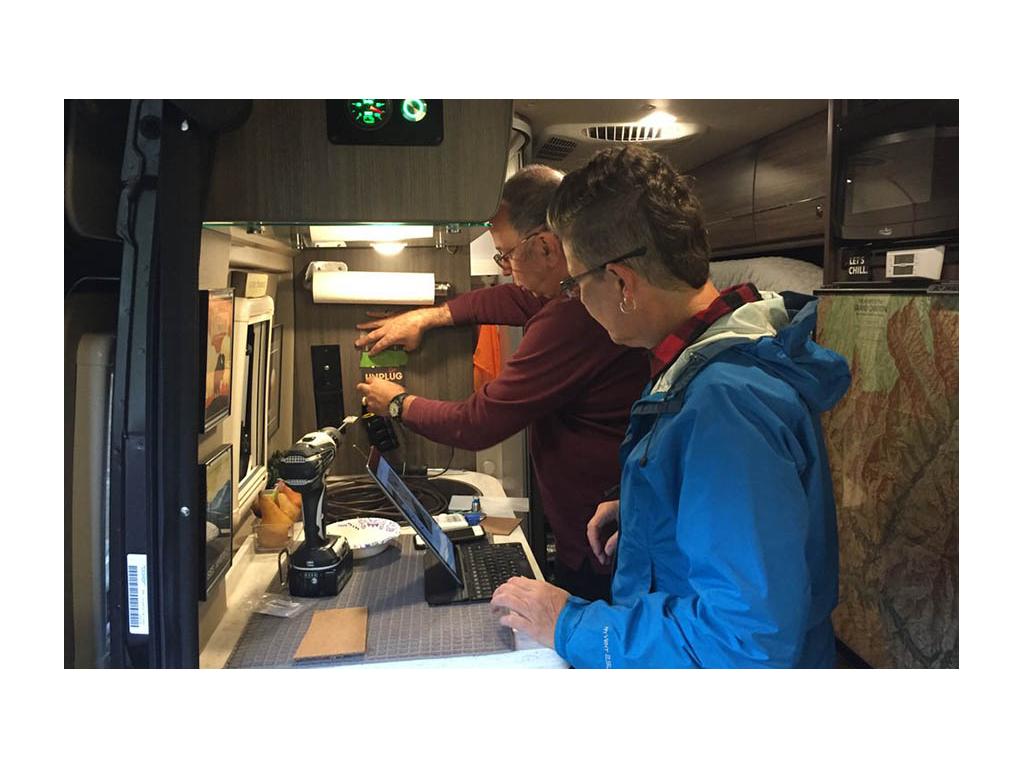 Greg and Noel mentoring Noel. Both are standing in Travato galley.