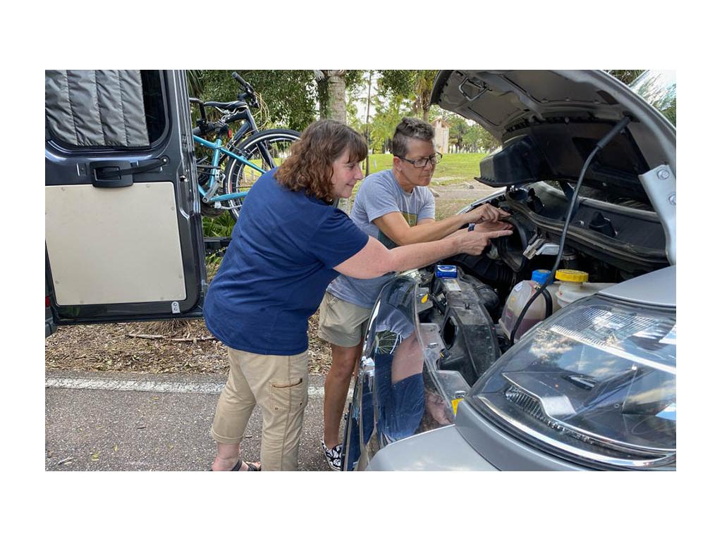 Joni showing Noel how to change air filter