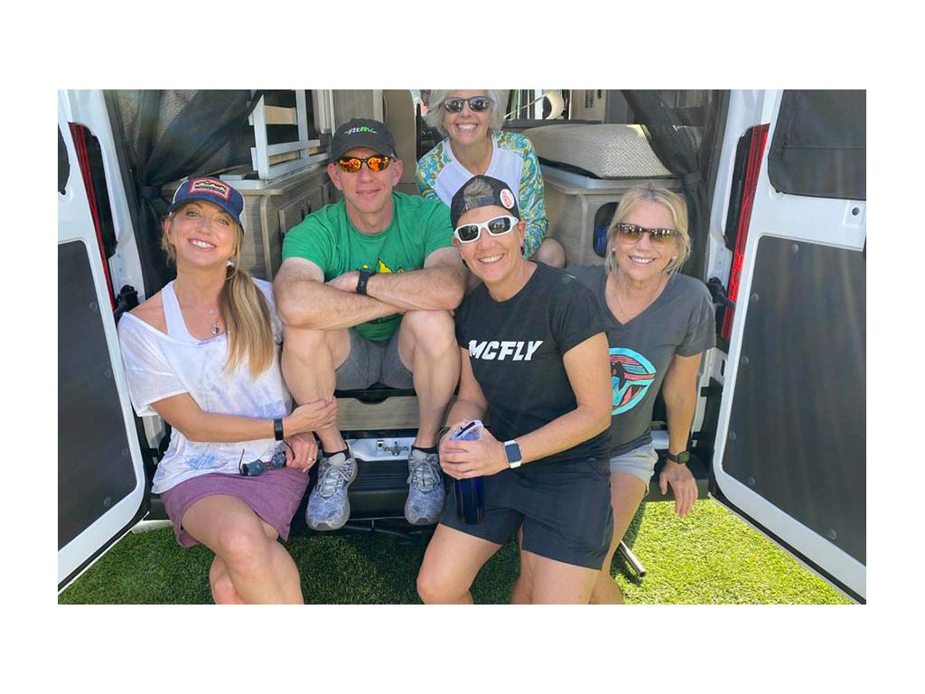Chris and Noel with three others in attendance at Tampa RV show. All sitting on back of Travato