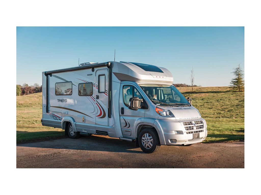 Winnebago Trend parked on gravel during sunset
