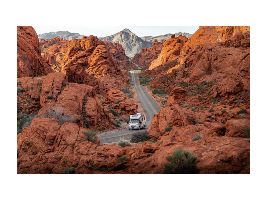 Winnebago Trend driving on a road through Red Rock Canyon.