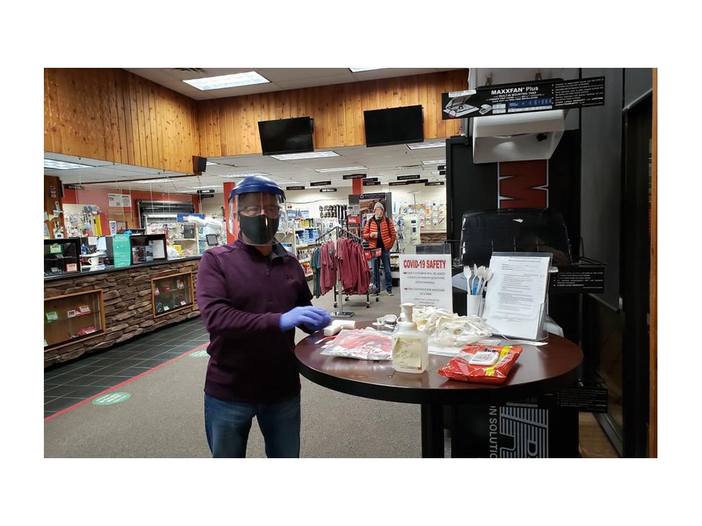 Check in station inside Factory Service Center with Covid safety rules, sanitizer, and masks