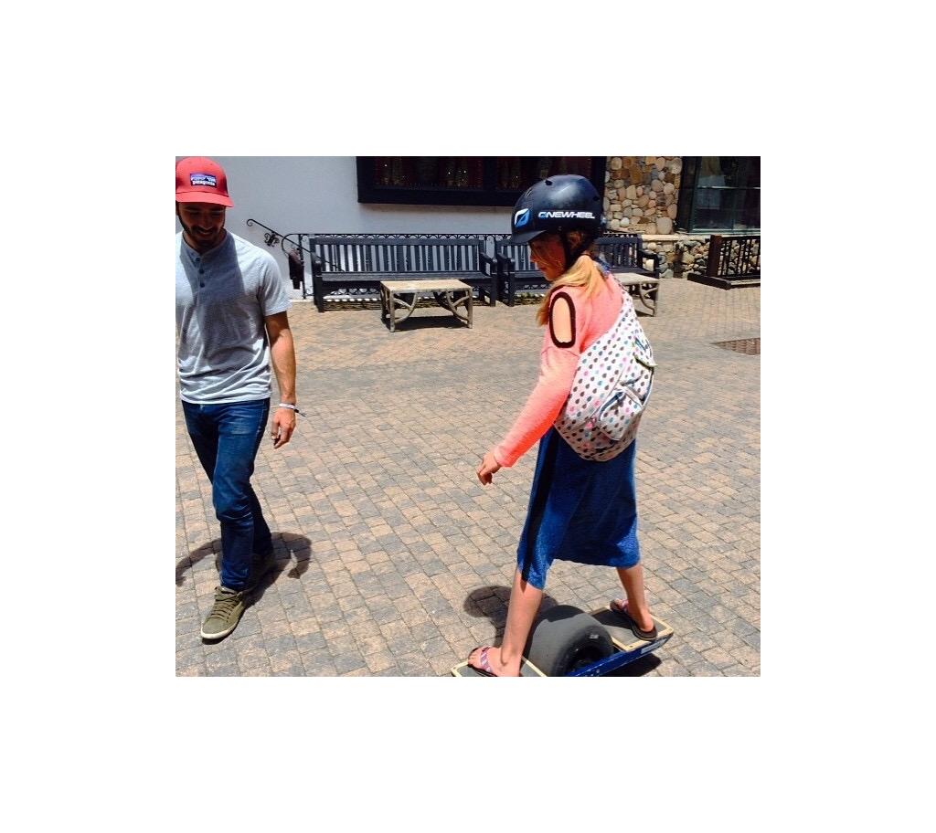 Abby trying out a one-wheel skateboard.