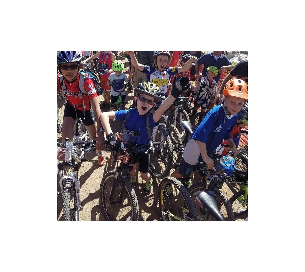 Group of kids on bikes about to race.