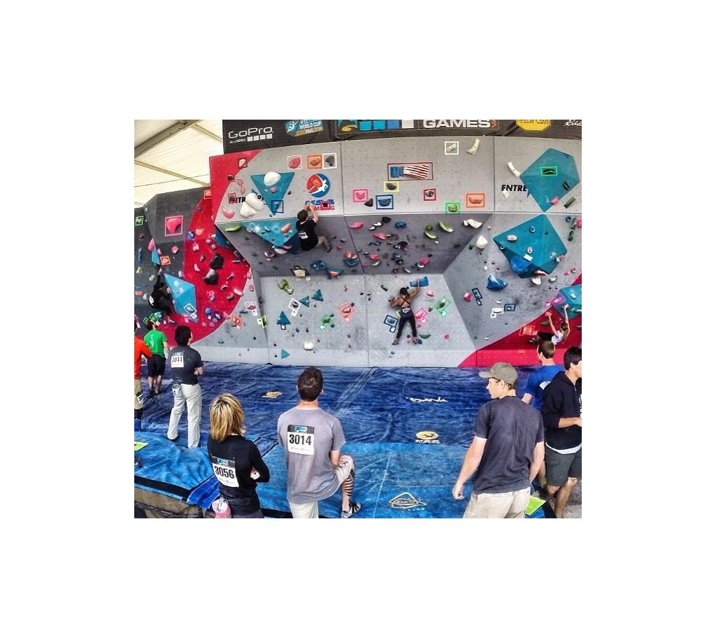 People climbing a bouldering wall.