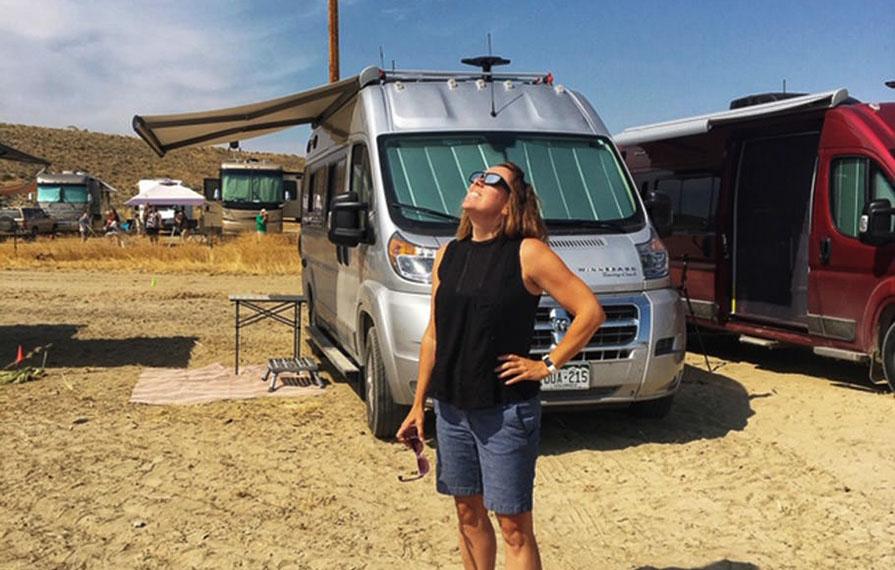 Jenny standing in front of two Travatos