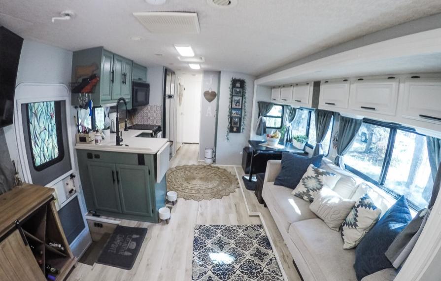 Finished living room renovation with green cabinets and light interior