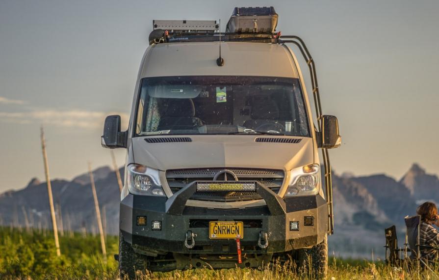 Winnebago Revel roof rack view of air conditioner and added roof box and solar panels