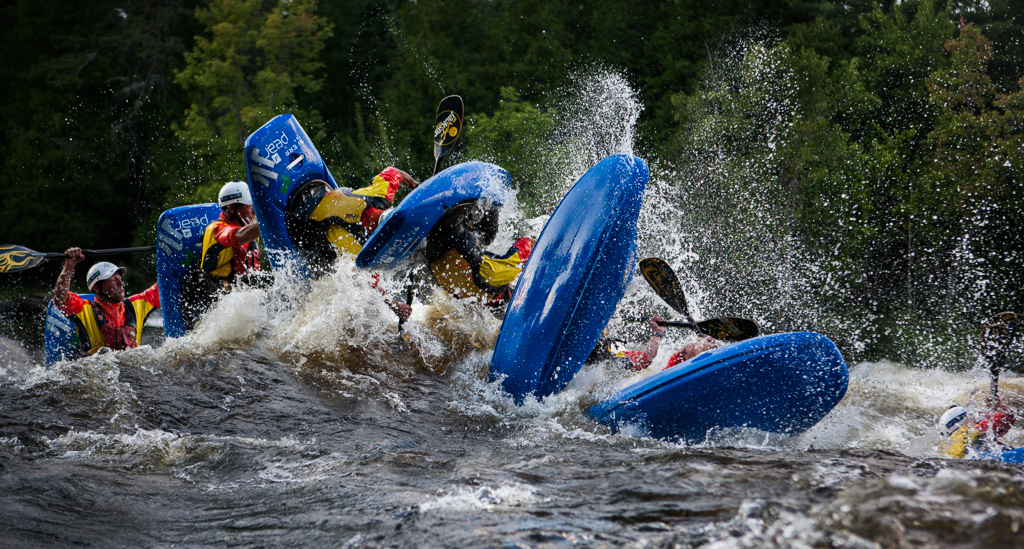 Sequenced shot of kayaker going over a wave.