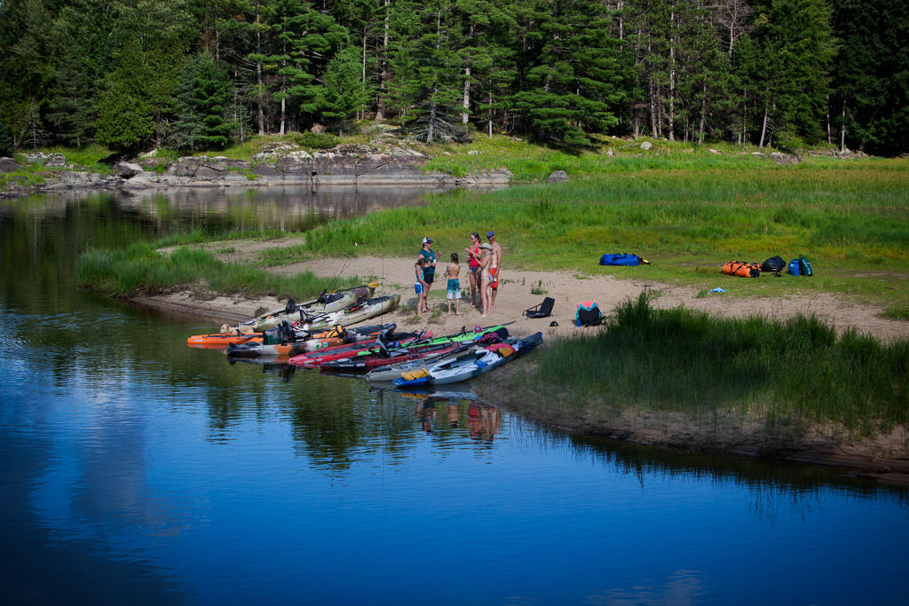 The McBeaths and Holcombes making a plan to set up camp on a small island.