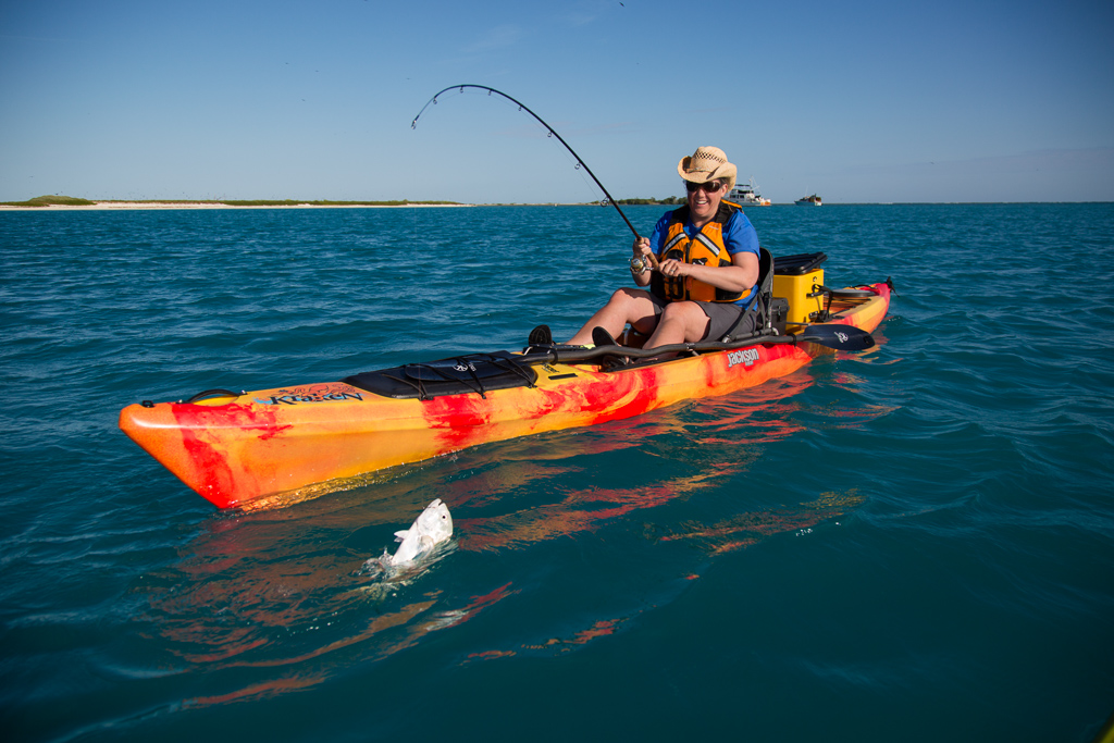 Kathy catching a fish from her kayak.
