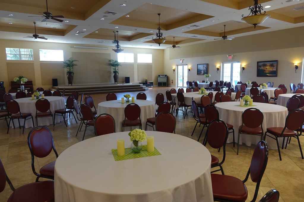 Clubhouse of resort with tables skirted for an event.