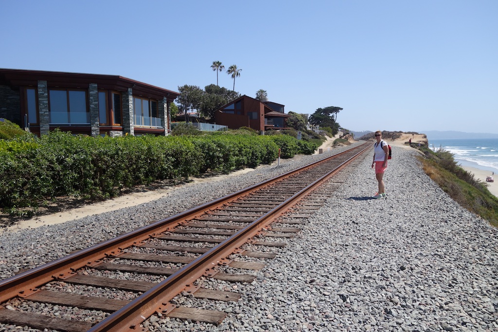 Terry standing next to Amtrak route with ocean in background