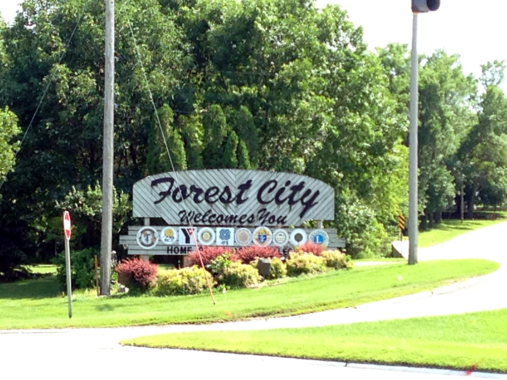 "Forest City Welcomes You" sign leading in to town.