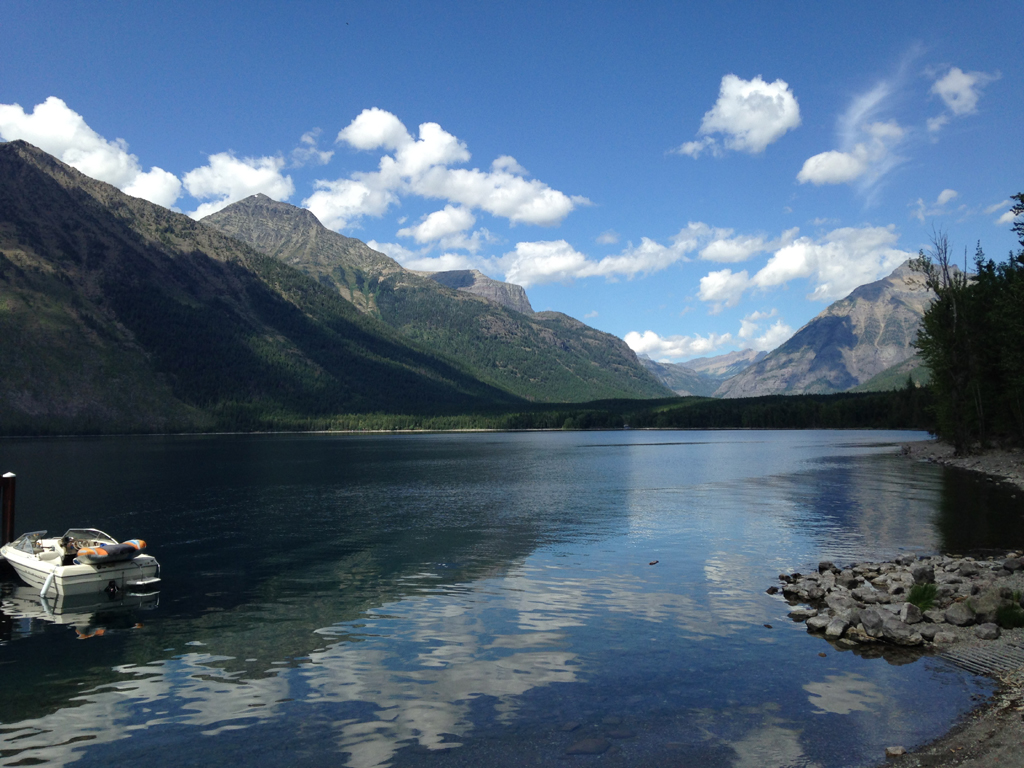 Boat on the water with mountains surrounding.