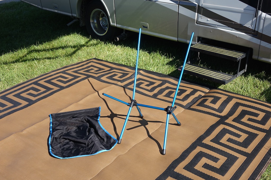 Helinox chair frame and cover on mat outside motorhome.