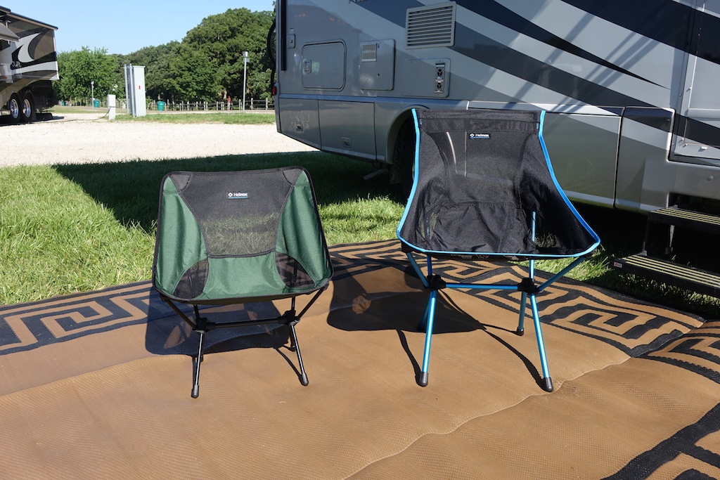 Two Helinox camping chairs set up outside a motorhome.