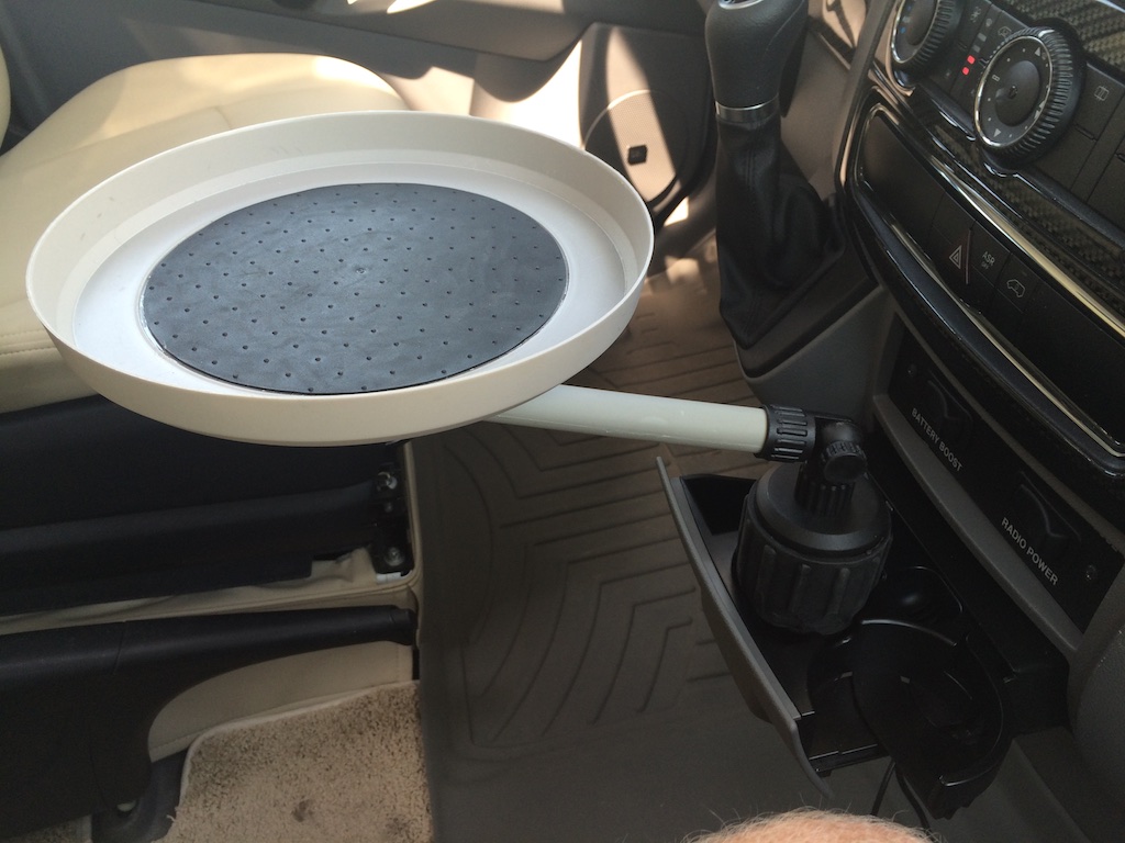 Tray table between driver and passenger seat.