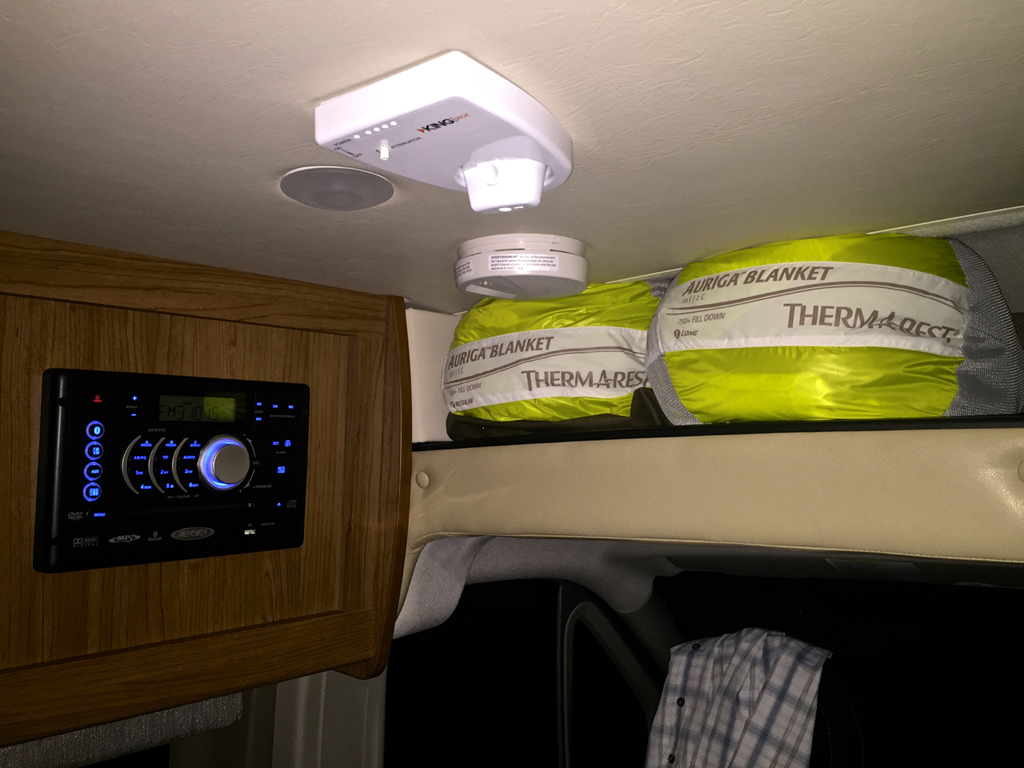 Control panel and blankets in upper storage.