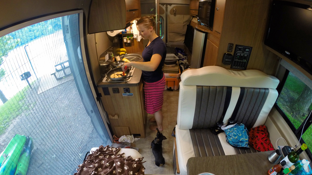 Woman cooking a meal on the stovetop.