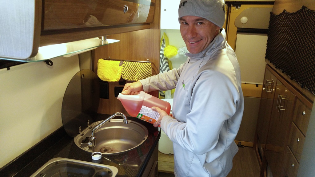James pouring antifreeze down kitchen sink.