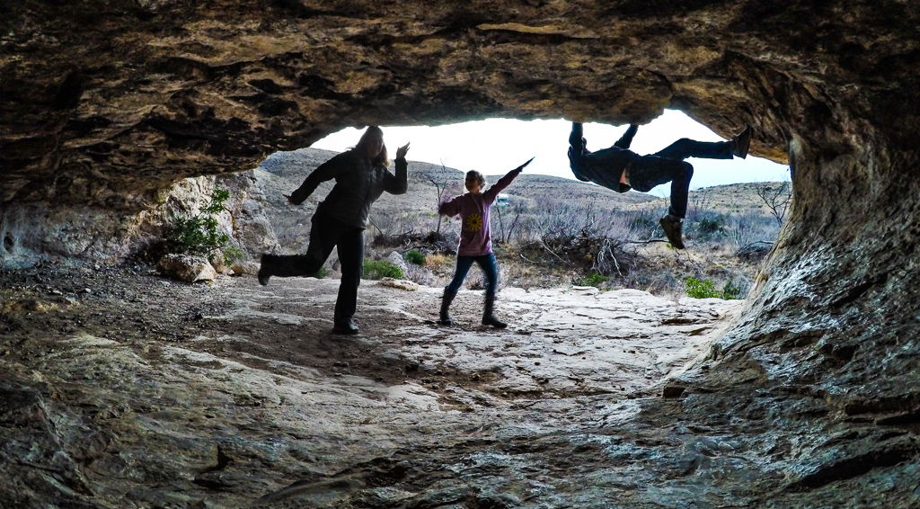 Family at an outlet from the caverns with daylight behind them.