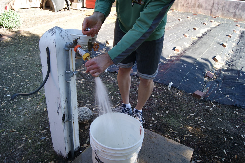 James testing water flow with regulator.