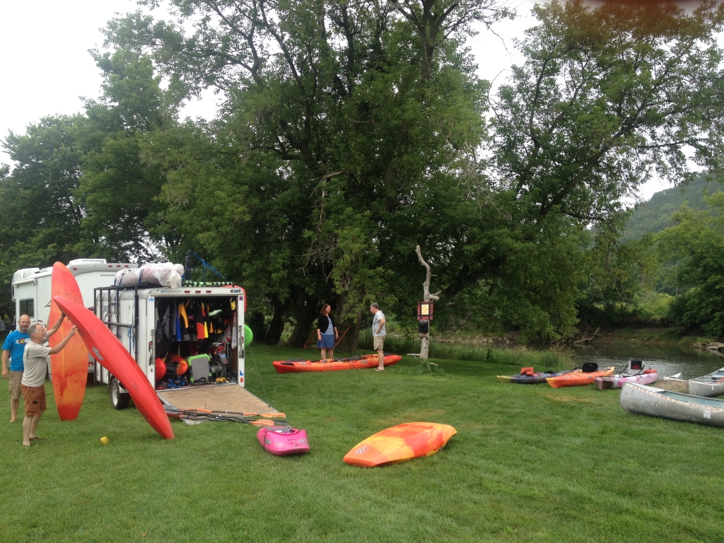 Group of people with kayaks and gear.