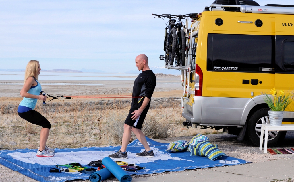 James and Stef exercising outside their Winnebago Travato.