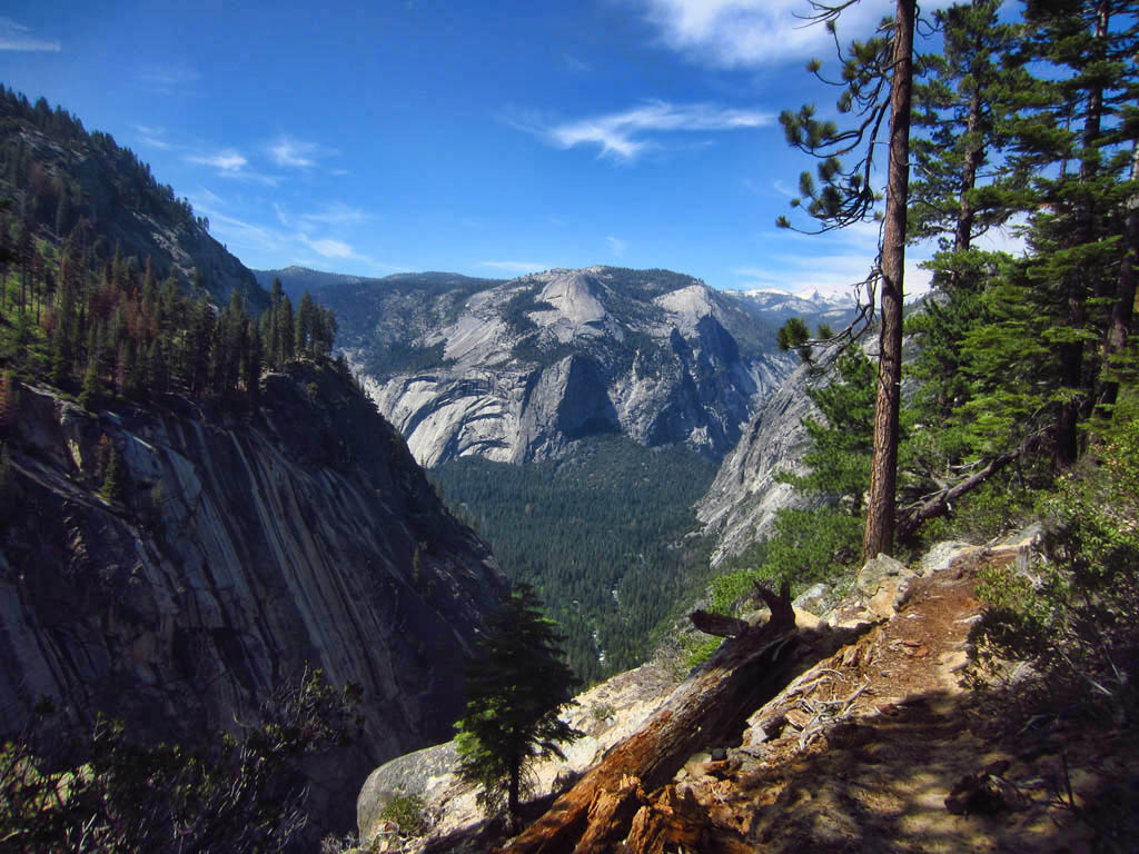 Valley through the mountain range with blue skies above.
