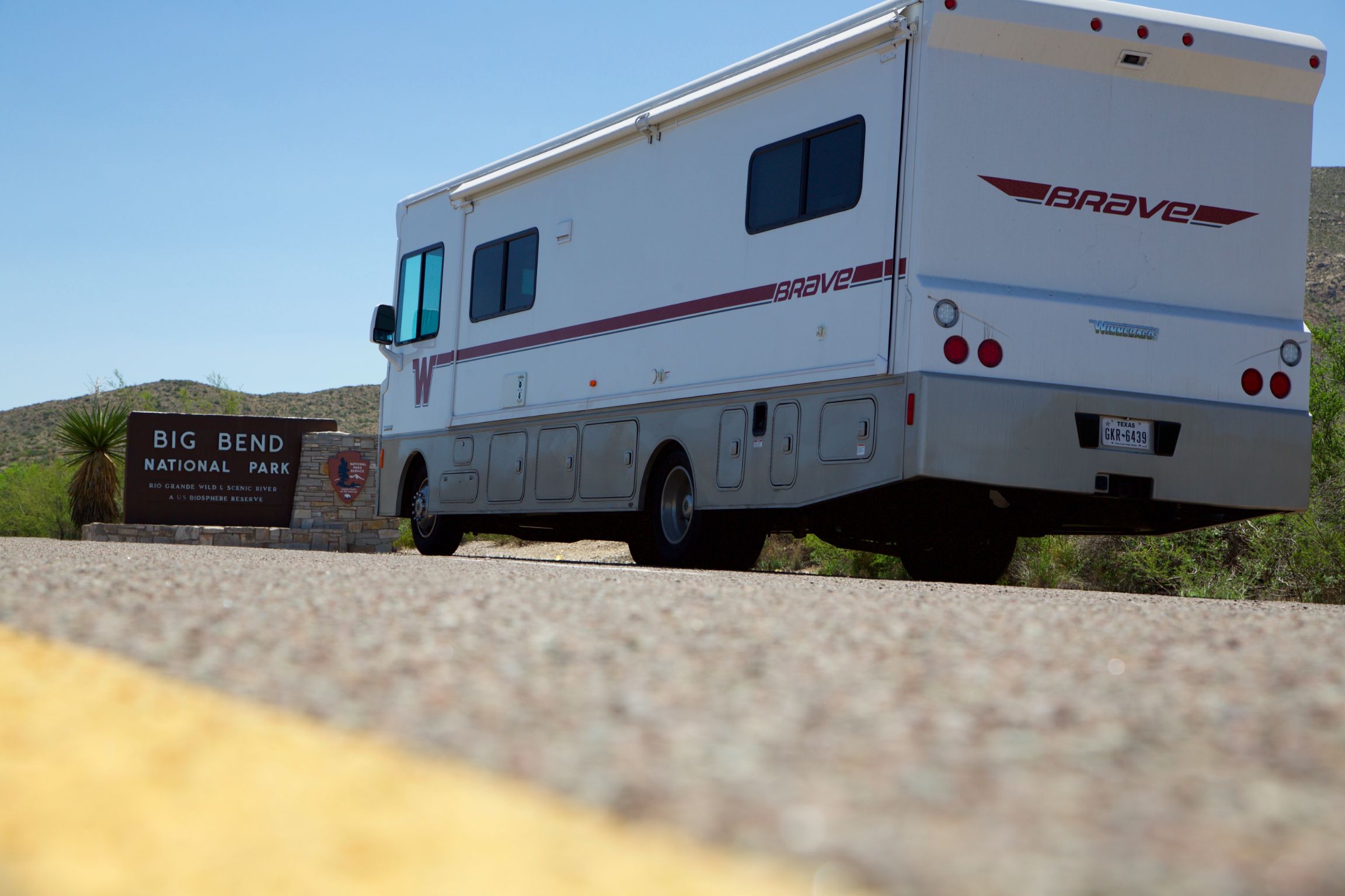 Winnebago Brave in front of Big Bend National Park sign.