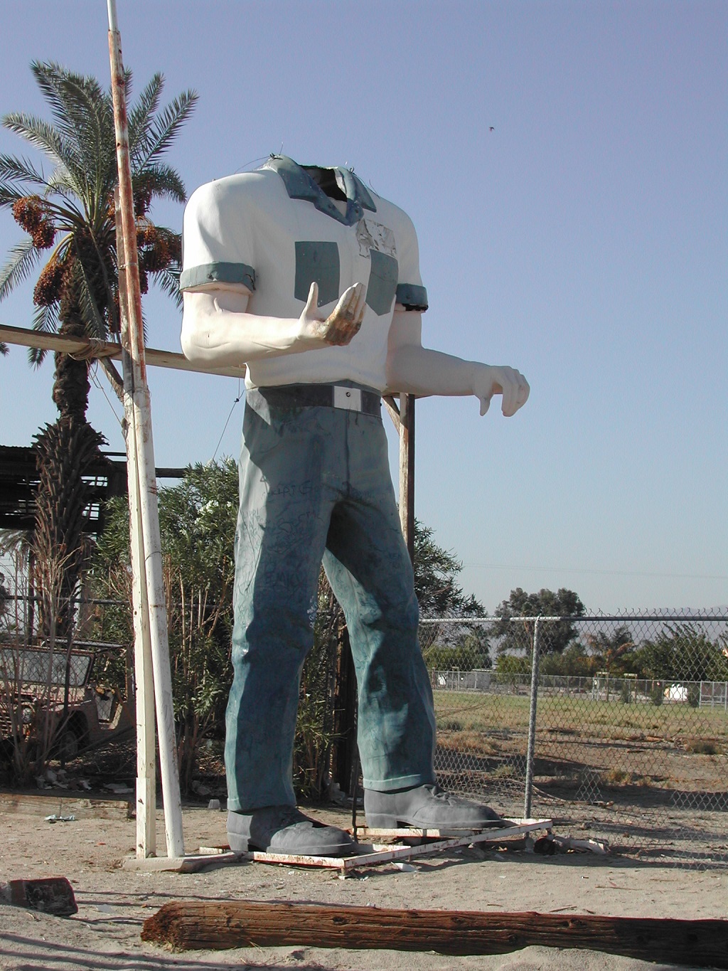 Large statue of a man without a head.