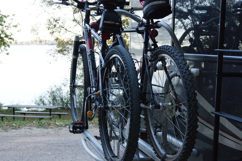 Two bikes on back rack attached to the back of an RV.