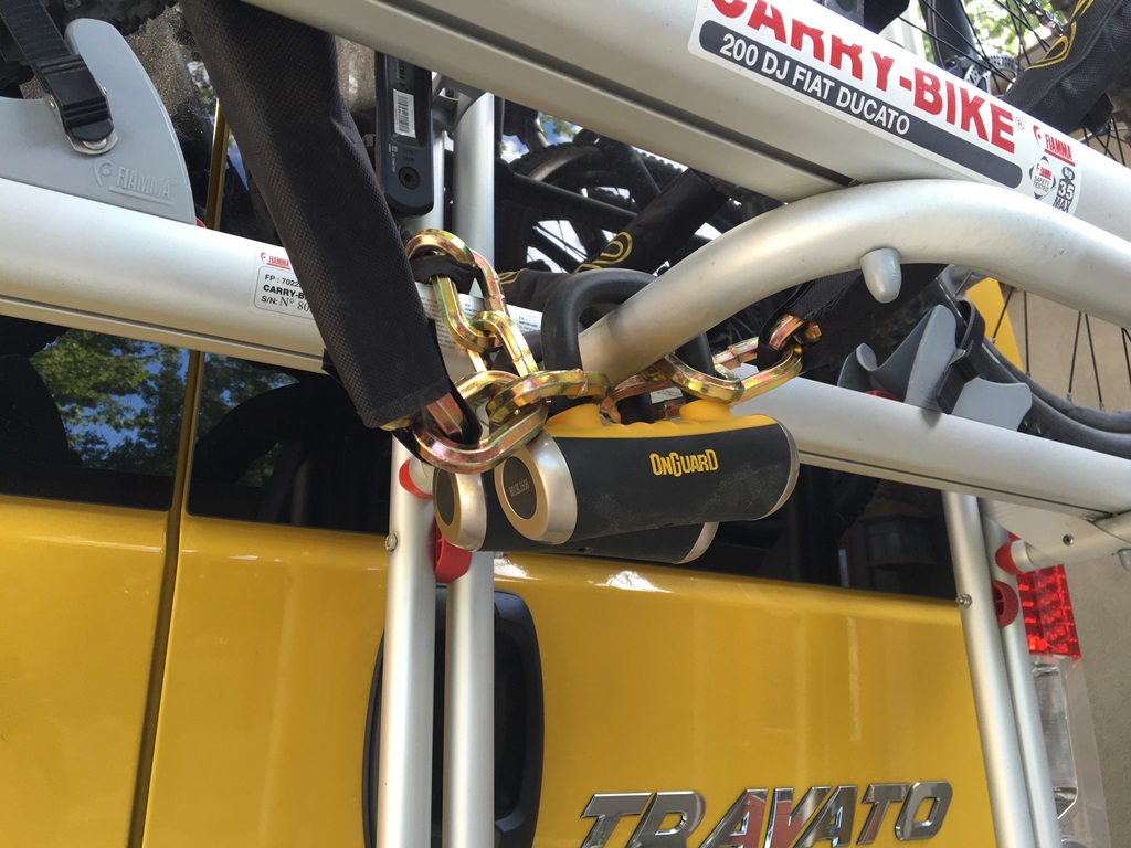 Bikes secured to rack by lock.