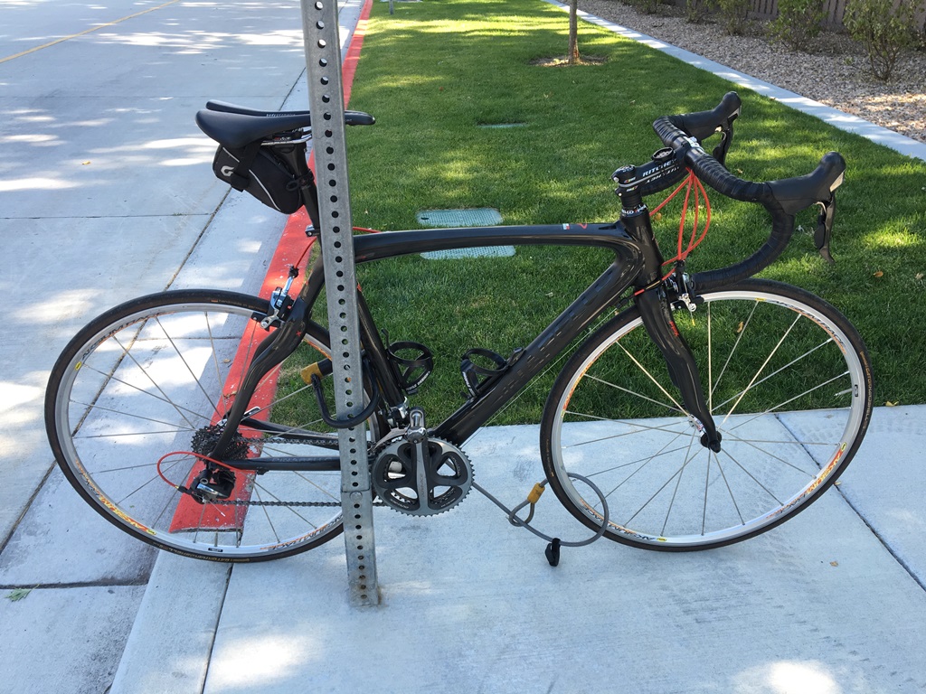 Bike locked to a sign with both wheels locked at well.