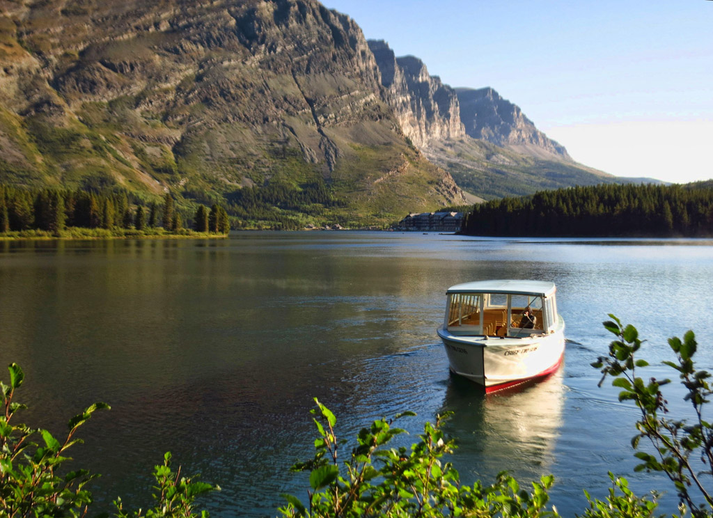 Boat on the water along mountains.