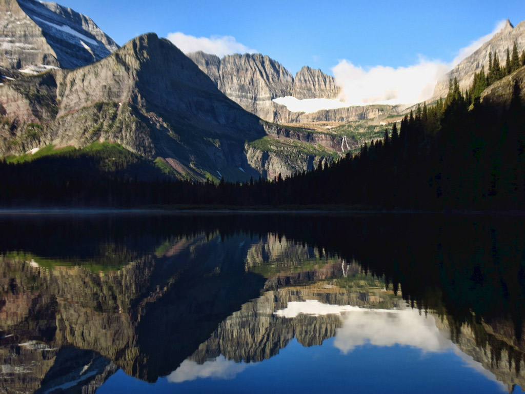 Water reflecting the mountains and Grinnell glacier.