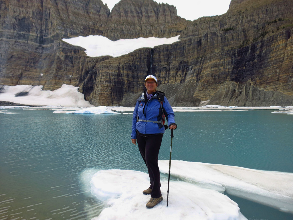 Woman standing on iceberg in the lake.