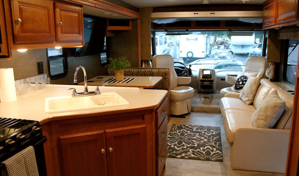 Winnebago Vista kitchen island, dinette, couch, and front cab area.