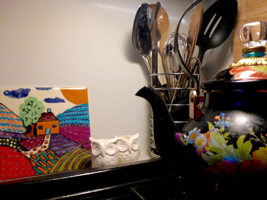 Kitchen utensils in in silver cup on kitchen counter