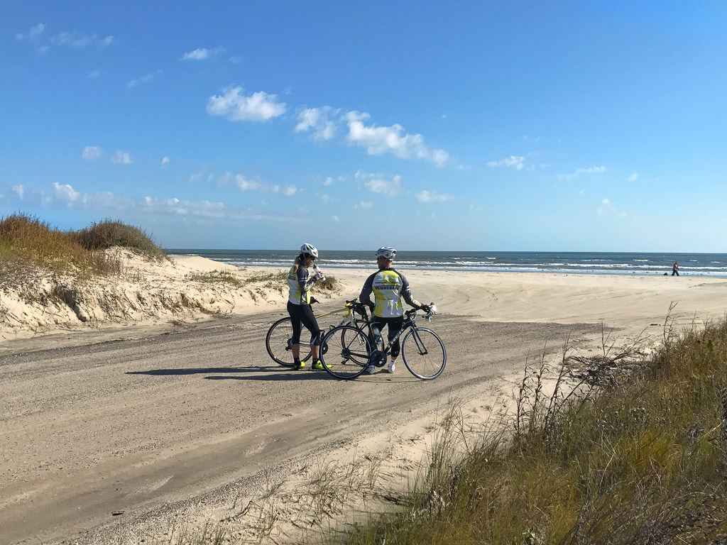 James and Stef on path that leads to beach and water